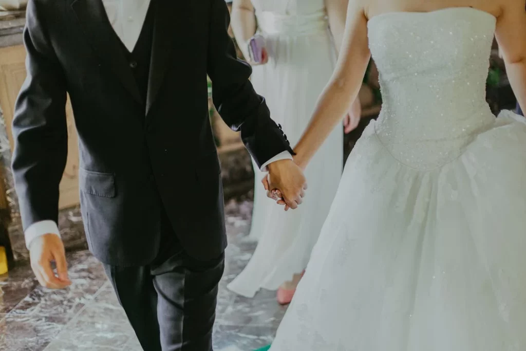 couple holding hands at a wedding